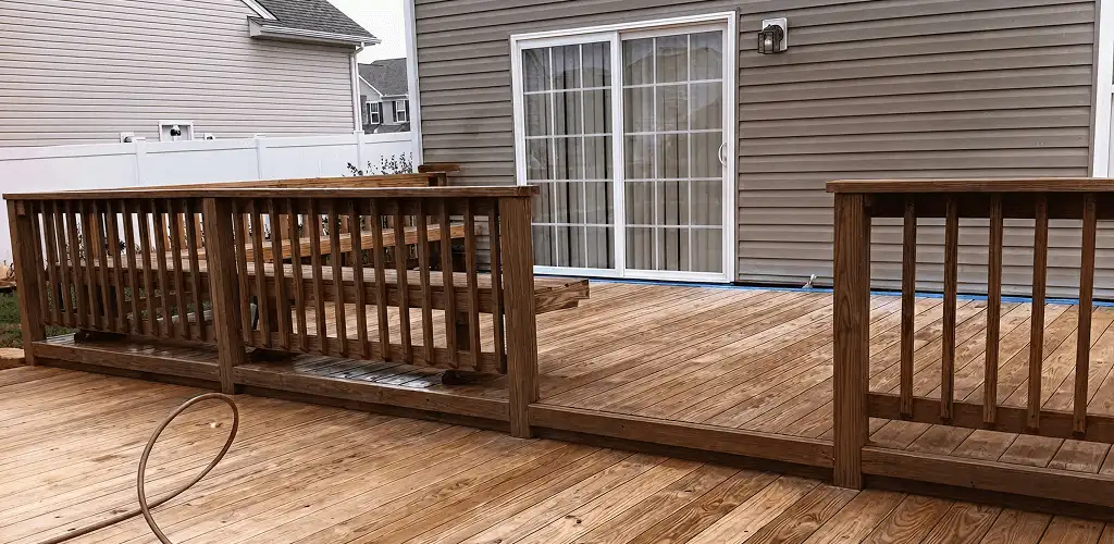 Deck sealing service protecting a backyard wood deck and railings in Colorado Springs, CO