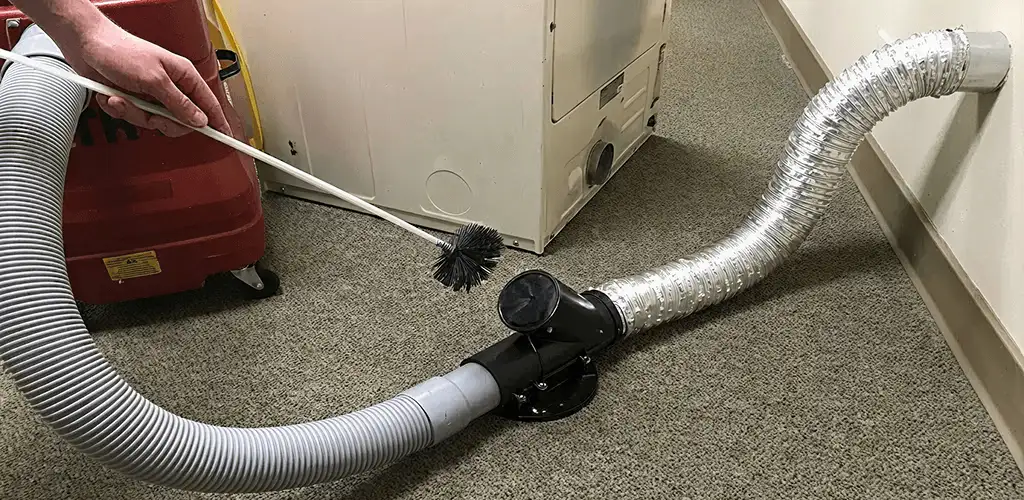 Dryer vent cleaning service removing lint from a dryer duct connection in Colorado Springs, CO