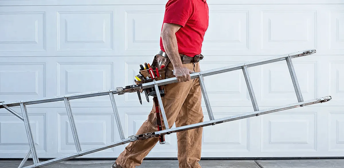 Garage door repair technician arriving with tools and ladder in Colorado Springs, CO