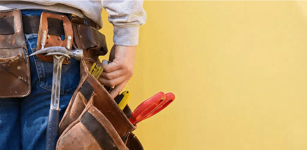 Handyman with tool belt ready for home repairs and maintenance in Colorado Springs, CO