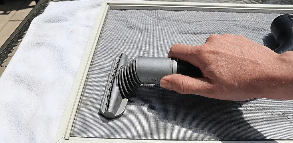 Window screen repair cleaning and fixing a damaged screen mesh in Colorado Springs, CO